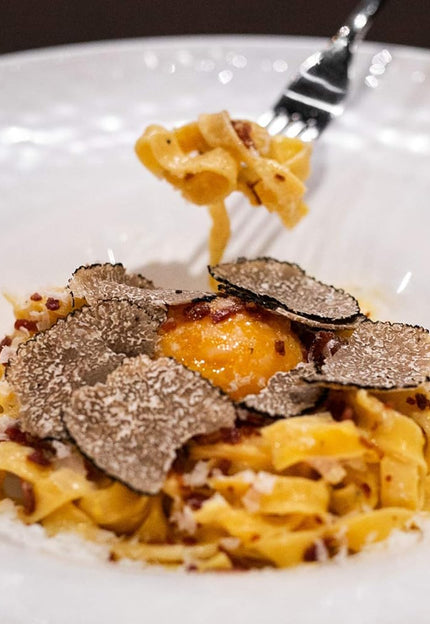 <em>Truffle</em> shaved on white sauce pasta is premium umami goodness.